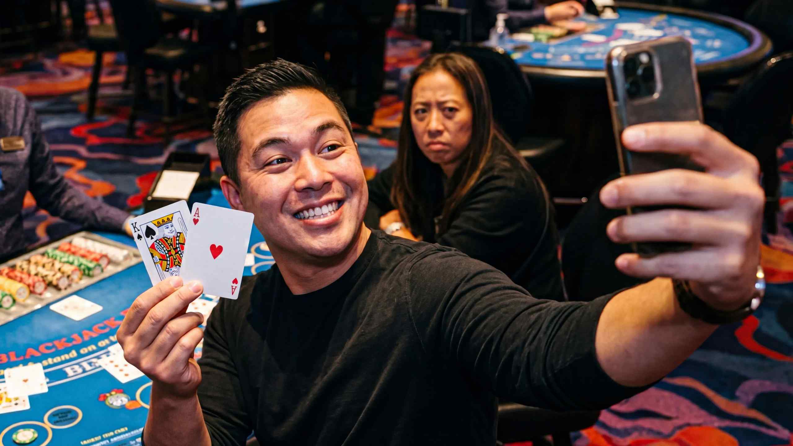 A poker player takes a selfie at the table.